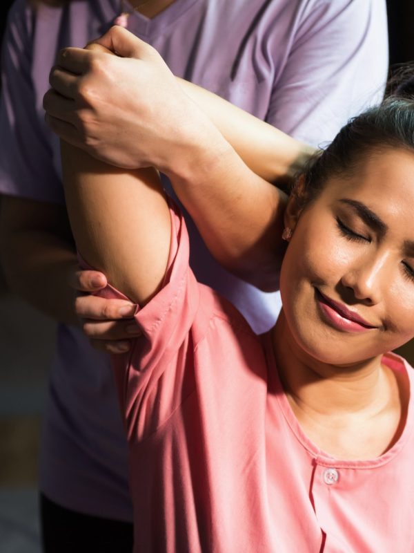 Thai arm and elbow reflexology massage therapy to young beautiful Asian woman on sofa in spa salon. Health care and Relax to heal pain concept. Alternative healthcare industry.